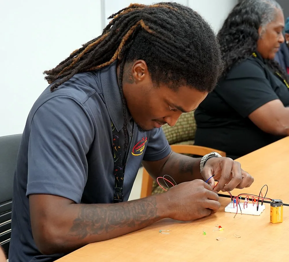 Electrical student wiring a circuit on a breadboard