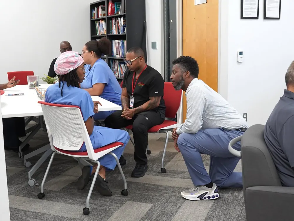 Students and staff talking in the student lounge